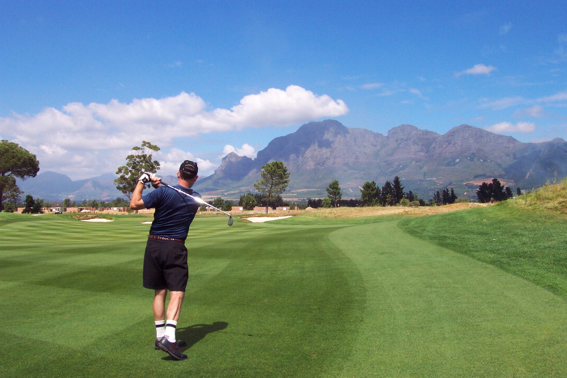 Golfer teeing off combining golf and safari in South Africa