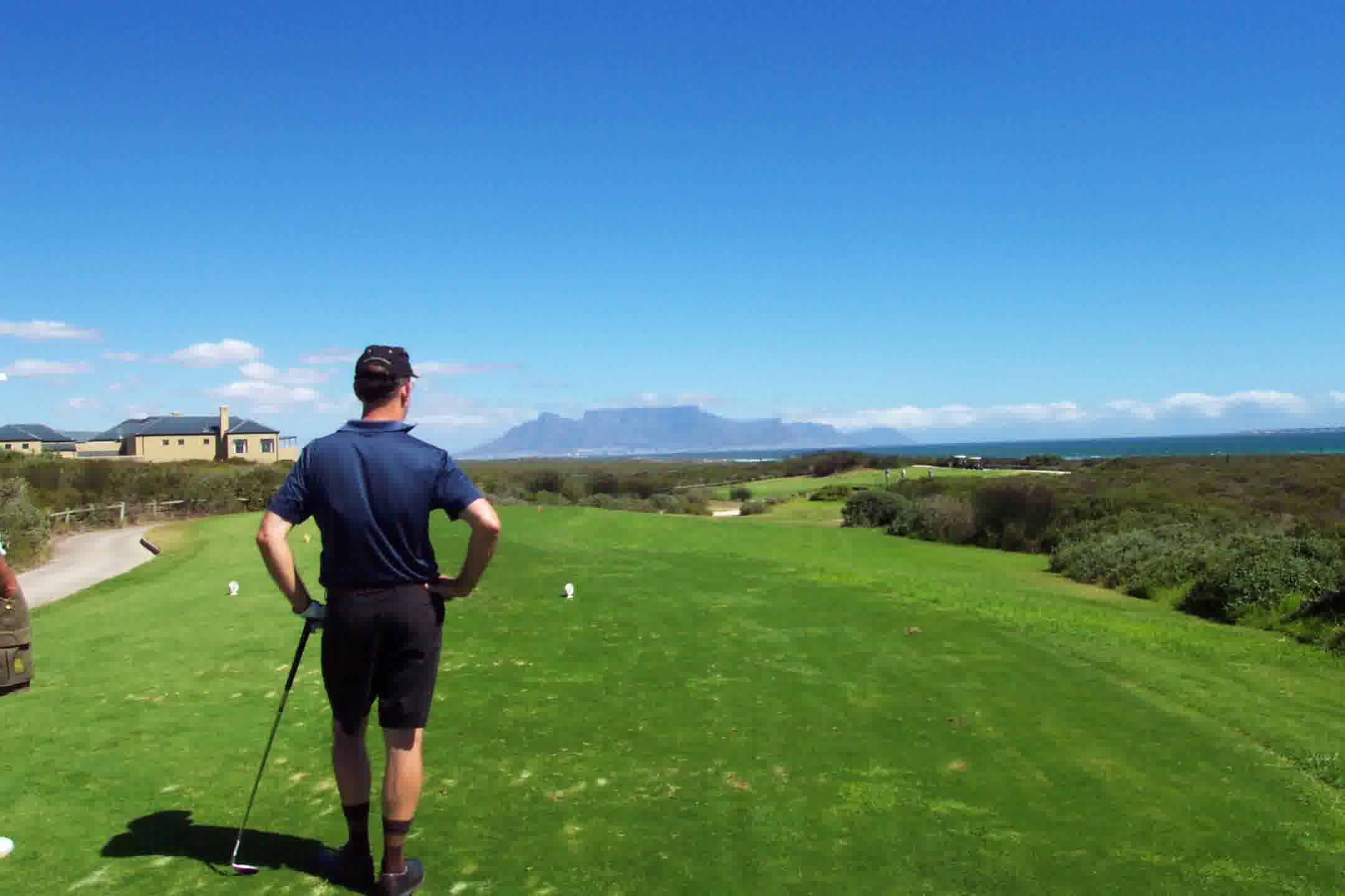 Golfer on a coastal South African golf course with ocean views